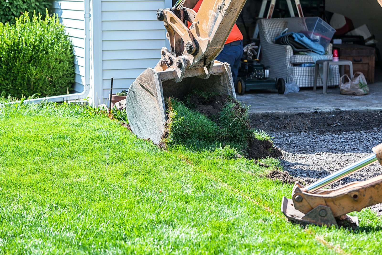 Backhoe Digging Up Lawn Turf To Widen New Driveway